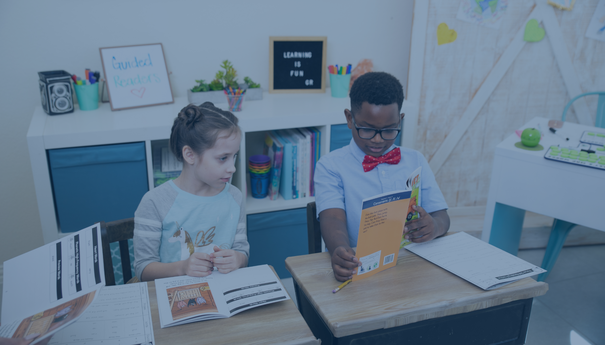 students sitting at desk learning together