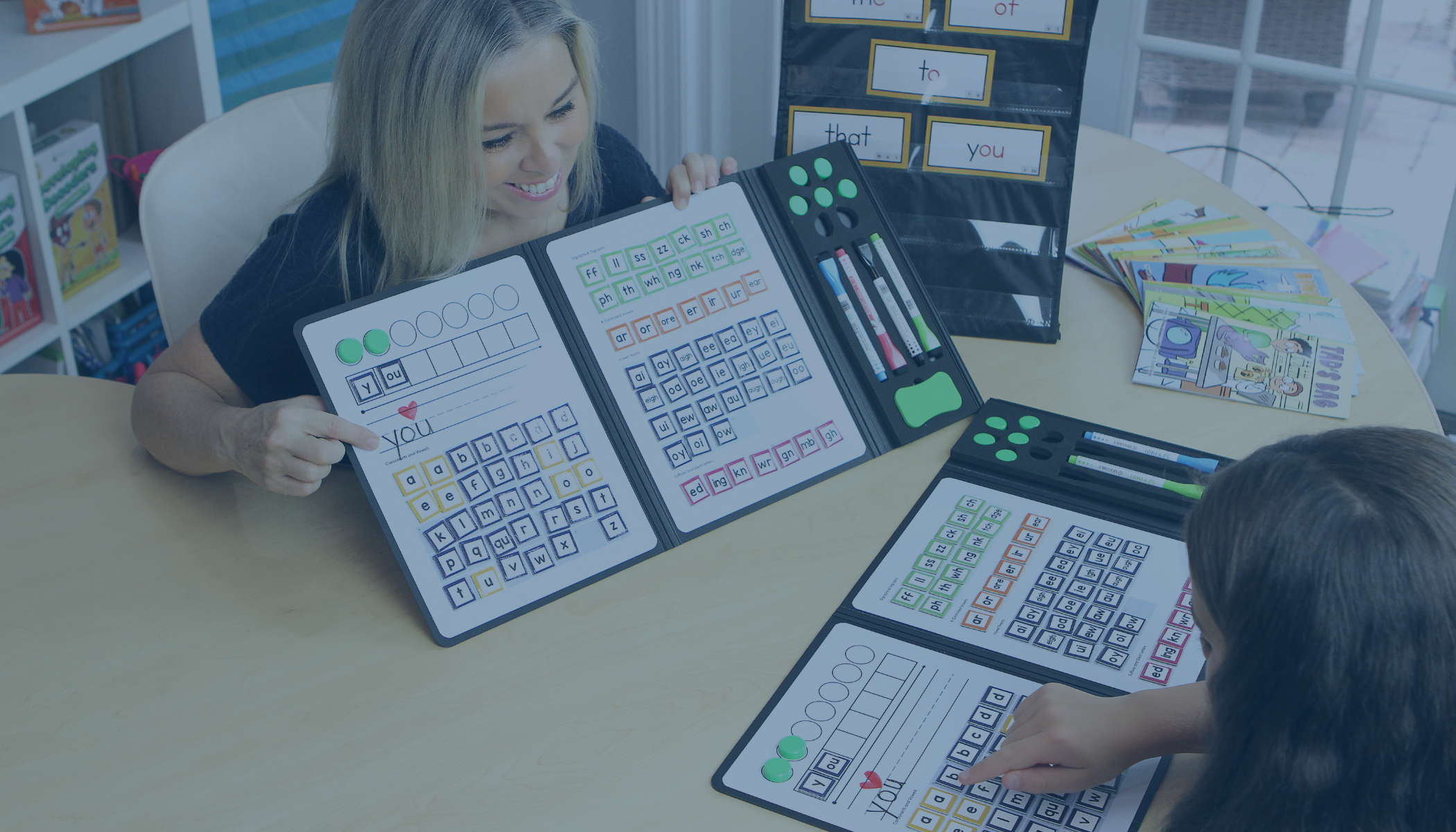 A teacher holding up a word-mapping binder.