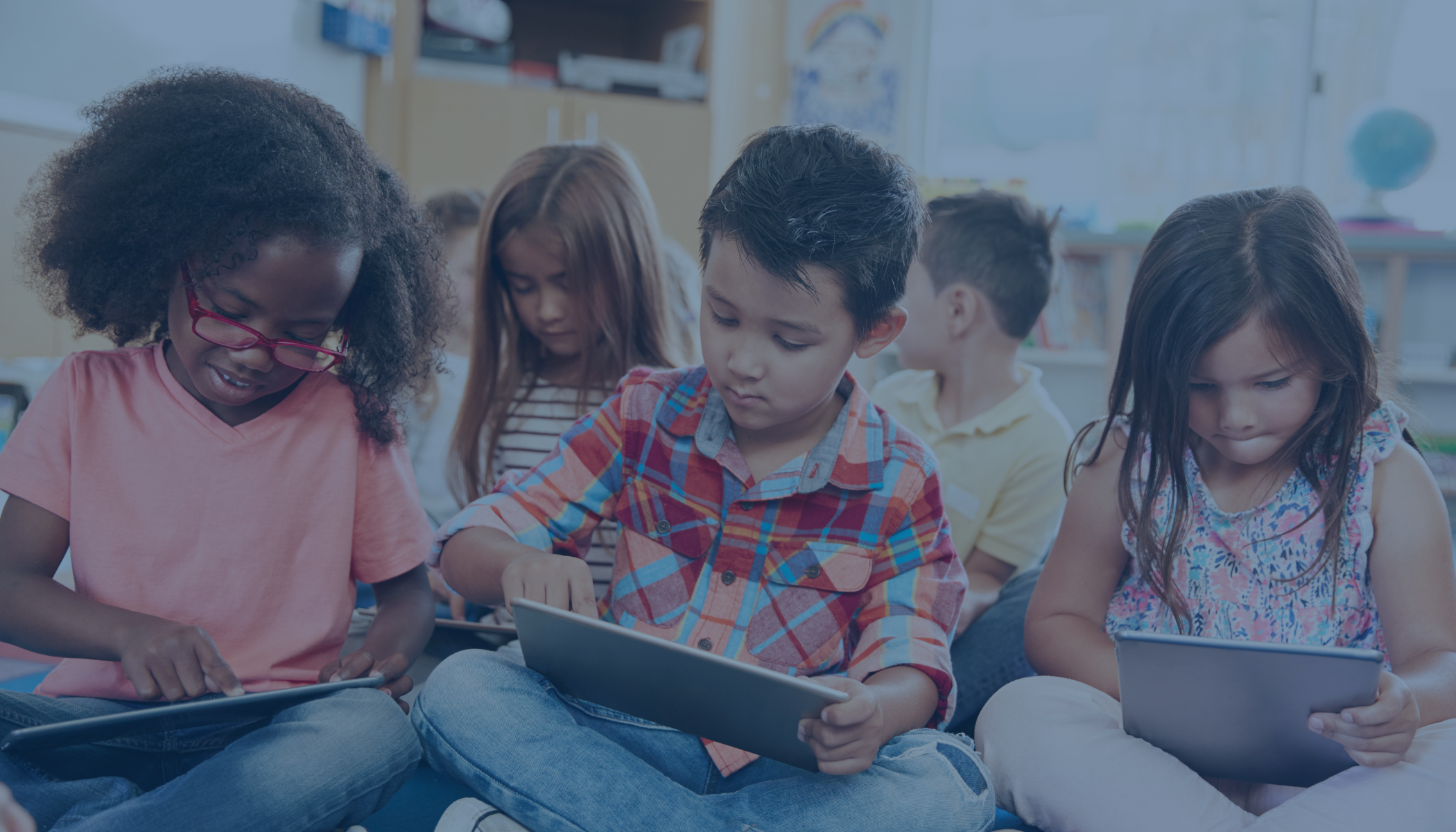 school aged students learning on tablets