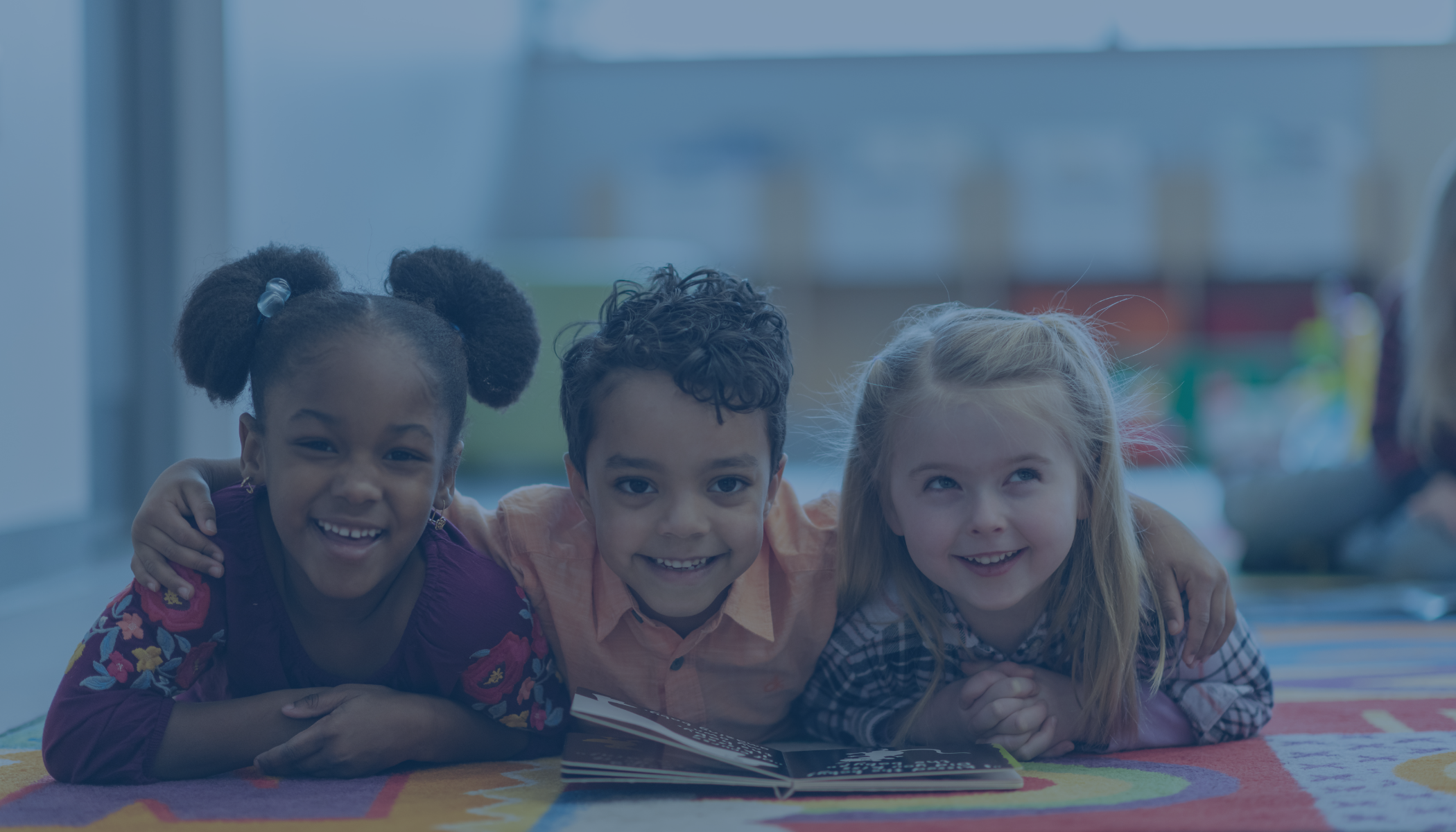 kids on the floor mat reading together