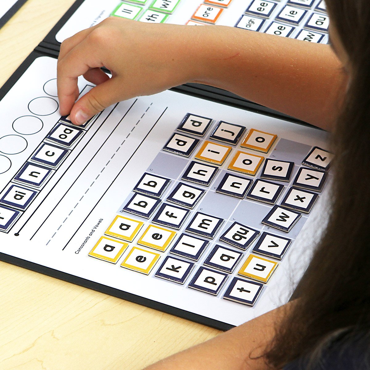 A student using a letter mapping board.