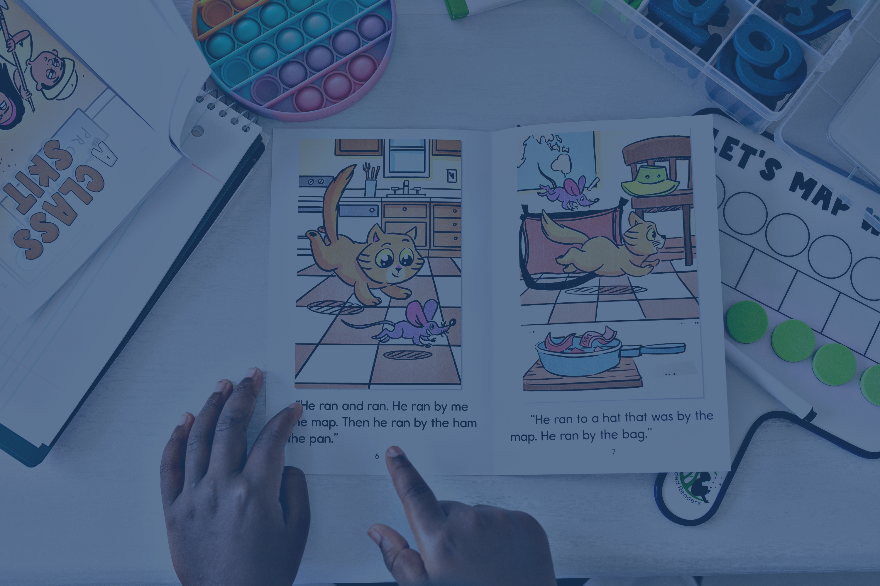 student hands pointing at book